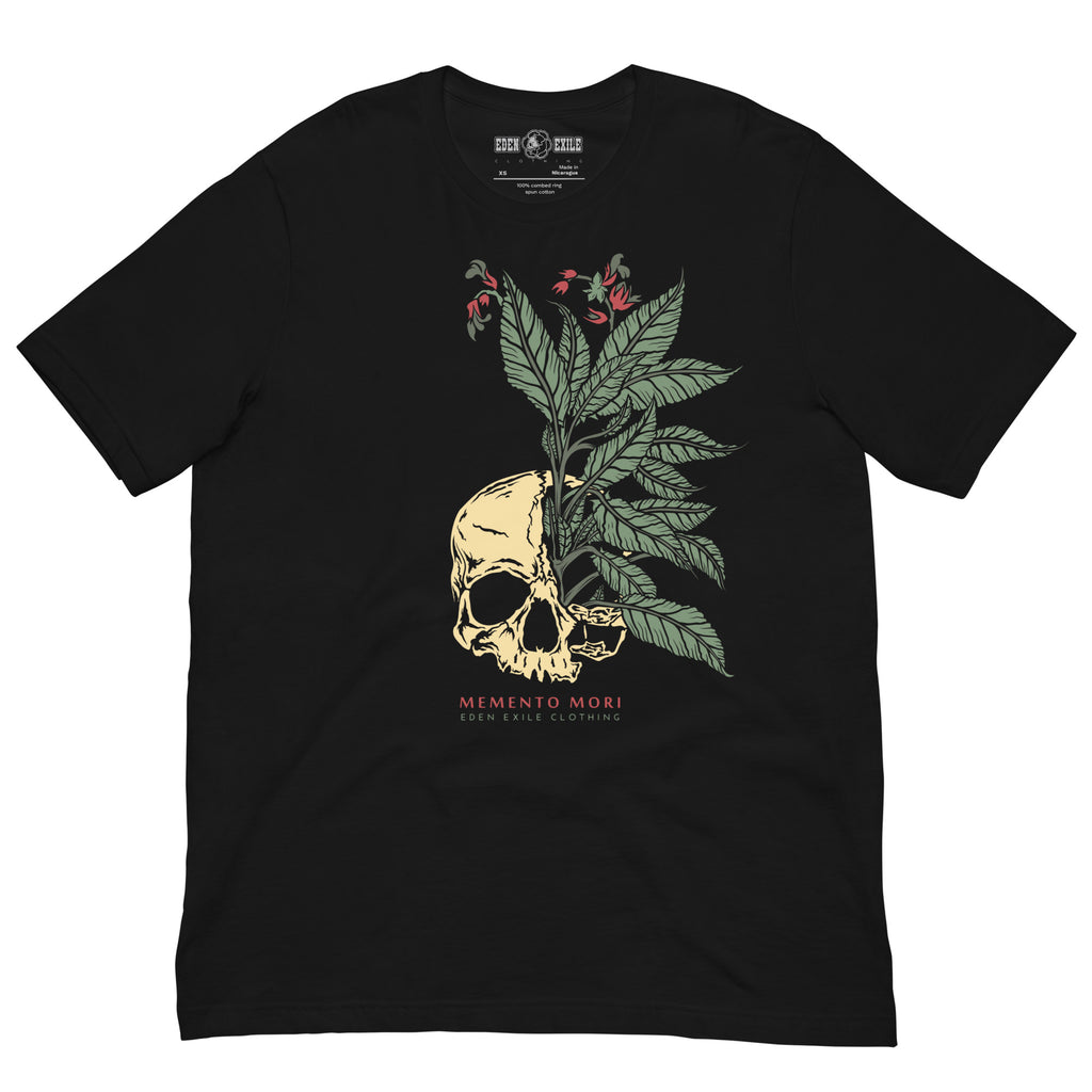 A black short-sleeve crewneck t-shirt featuring a graphic print of a beige skull with green leaves and small red flowers growing from it. Below the graphic, the text 'MEMENTO MORI' and 'EDEN EXILE  CLOTHING' are printed in red and beige.