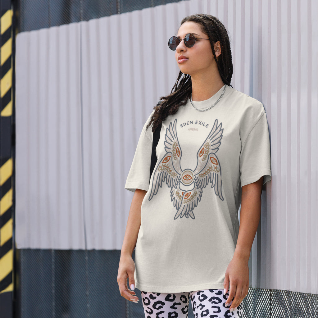Woman wearing a graphic t-shirt with an angel design against a striped wall