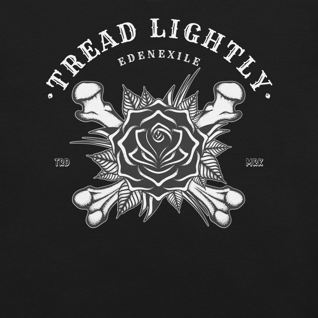 Black and white graphic with rose and bones design and 'Tread Lightly' text on a black background