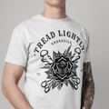 A man wearing a white short-sleeve t-shirt with a black graphic print on the front. The graphic features the text 'TREAD LIGHTLY.