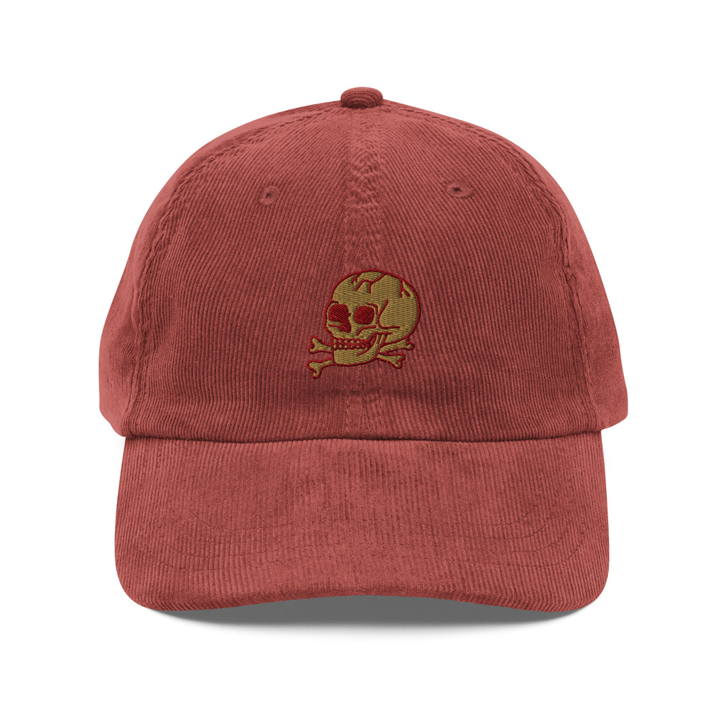 Red cap with a skull and crossbones design on a white background