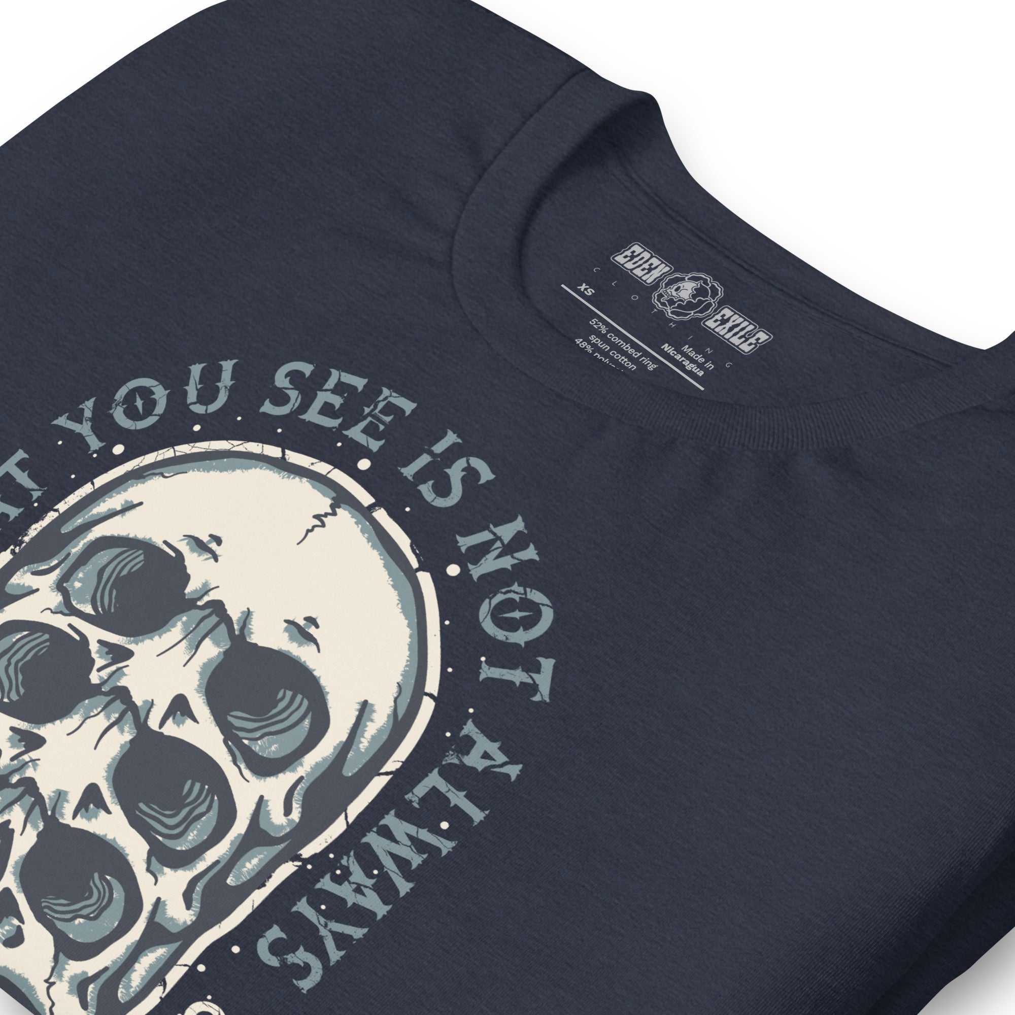 Heather navy t-shirt with surreal skull design and text saying :  WHAT YOU SEE IS NOT WHAT IS THERE .