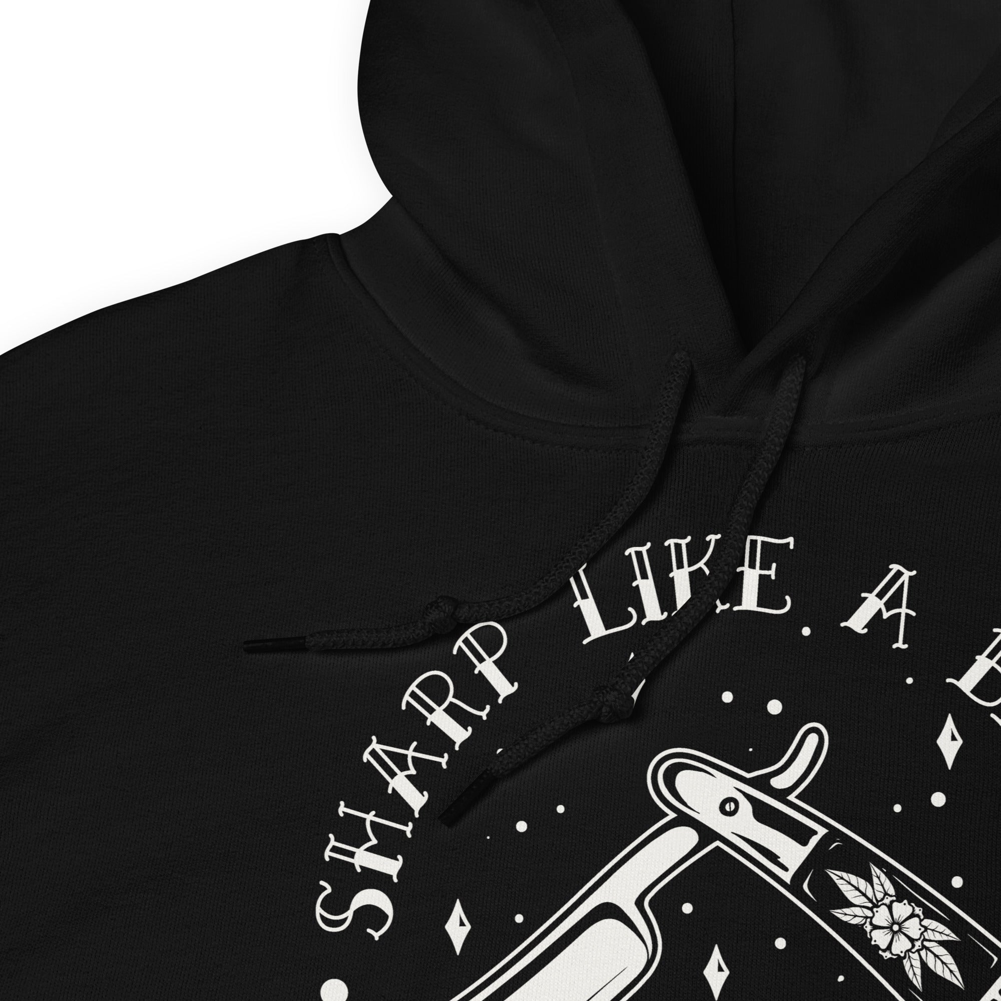 Black hoodie with graphic design of  traditonal tattoo of a razor and text on a white background
